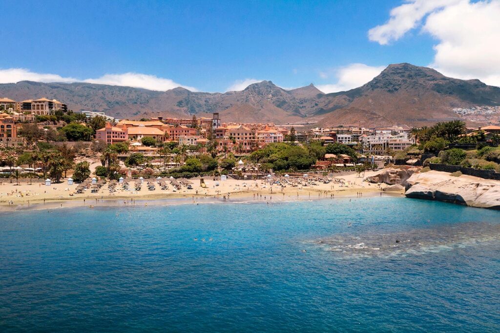 Arena dorada y aguas cristalinas de la playa del Duque Costa Adeje con Bandera Azul Tenerife