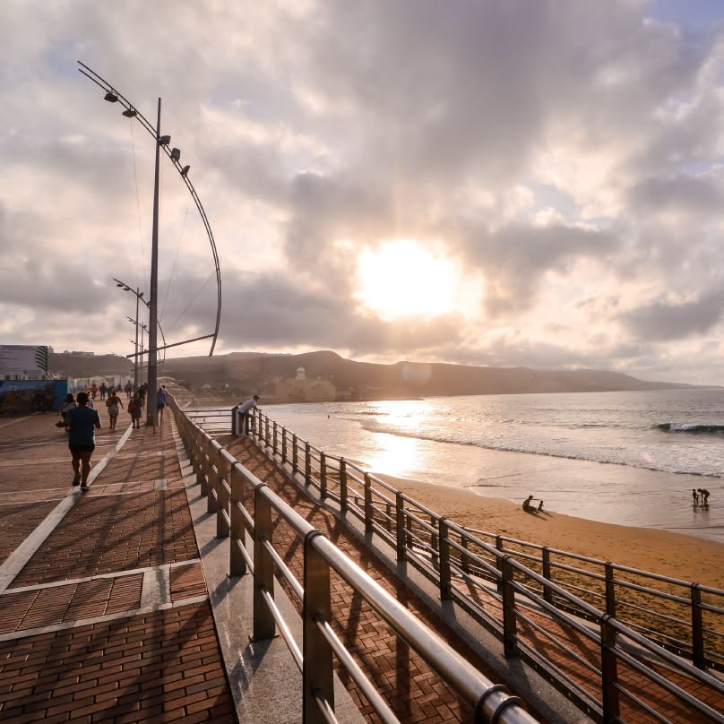 Atardecer en Playa Grande en Las Canteras con el paseo marítimo y Las Palmas de Gran Canaria al fondo