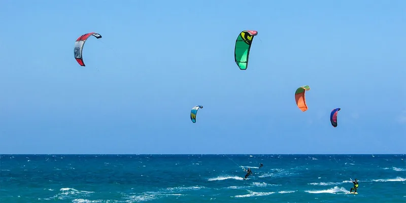 Kitesurfistas en la Playa El Cabezo El Médano con Montaña Roja al fondo en Tenerife sur