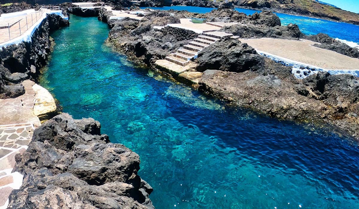 piscinas naturales de El Caletón con bañistas Piscinas naturales de El Caletón en Garachico, Tenerife, formadas por lava volcánica
